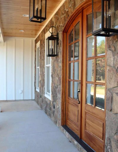 Rustic Entrance of Custom Built Home with Sconces